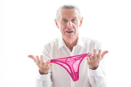 71084774-closeup-of-confused-senior-man-holding-panties--1-